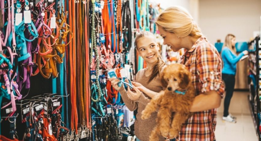 mãe e filha escolhendo produtos em um pet sho